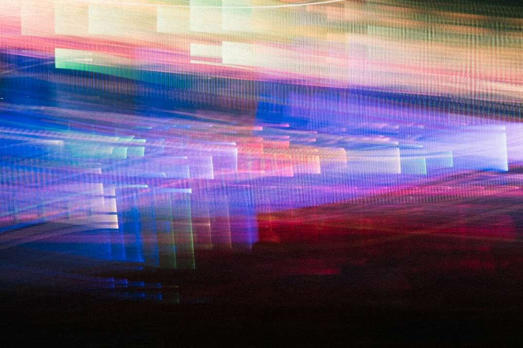 Laptop screen showing lines of colorful programming code